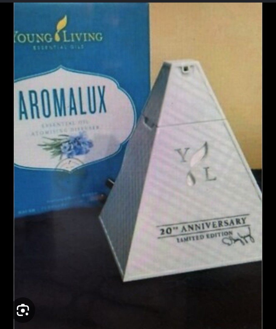 Aromalux Diffuser (Category: Fragrance & Deodorants) located in Singapore. Submitted by myhome99 (Listing ID 1453433271, Image 1). Description: Hey there! Up for grabs is this super cool Young Living Aromalux Atomising Diffuser, a limited edition piece celebrating their 20th anniversary! It's got a unique pyramid design and can function as an aroma diffuser, air purifier, and atomiser all in one. You can pop in either a 5ml or 15ml essential oil 