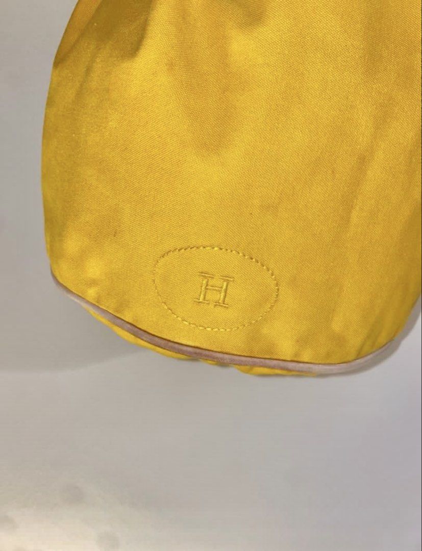 Authentic Hermes Polochon Mimile Canvas Drawstring Backpack (Category: Luxury Bags & Wallets) located in Mandaluyong City. Submitted by wear_your_style (Listing ID 1453476234, Image 2). Description: Silent luxury ang atake. Bought this at the preloved store in Japan for ₱25K. This piece still retails up to ₱48k in some websites. This is already vintage. Material is canvas (100% thick cotton) but the drawstring is leather. Approx 14.5 inches long 