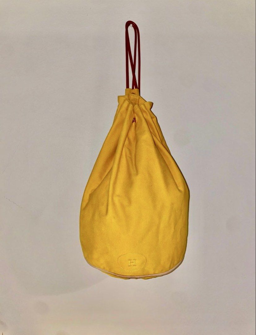 Authentic Hermes Polochon Mimile Canvas Drawstring Backpack (Category: Luxury Bags & Wallets) located in Mandaluyong City. Submitted by wear_your_style (Listing ID 1453476234, Image 1). Description: Silent luxury ang atake. Bought this at the preloved store in Japan for ₱25K. This piece still retails up to ₱48k in some websites. This is already vintage. Material is canvas (100% thick cotton) but the drawstring is leather. Approx 14.5 inches long 
