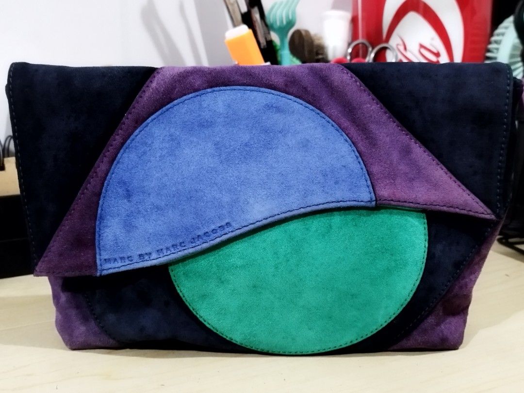 Authentic Marc by Marc Jacobs Etta Suede Patchwork Clutch Bag (Category: Luxury Bags & Wallets) located in Quezon City. Submitted by redragtag (Listing ID 1453443287, Image 1). Description: Selling an authentic, rare archival Marc by Marc Jacobs "Etta" Patchwork Clutch. Super unique geometric colorblock design made of soft suede panels (Navy, Purple, Jungle Green, and Black). A great evening statement piece from the discontinued MBMJ line! ✨ BONU