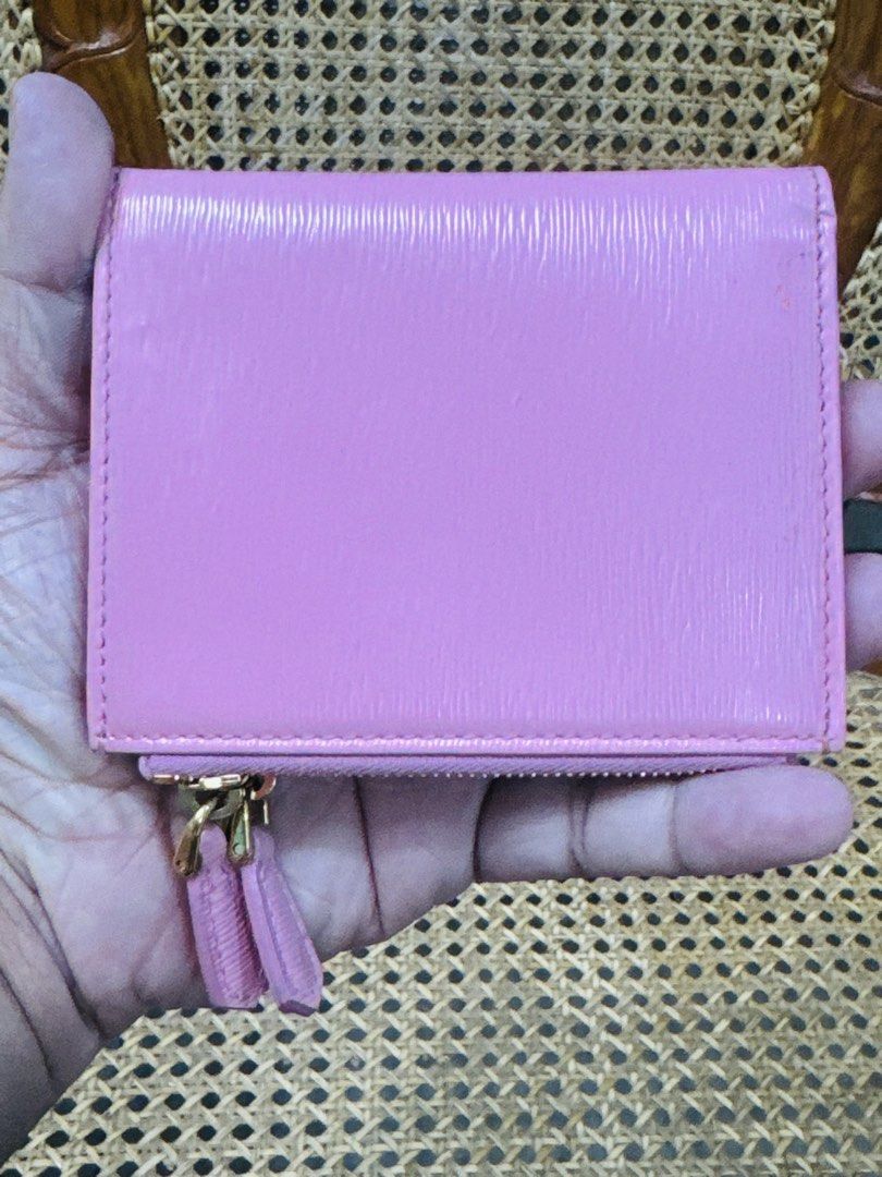 [AUTHENTIC] Prada Pink Bi-Fold Wallet (Category: Luxury Bags & Wallets) located in Santa Rosa. Submitted by rjaarmblo (Listing ID 1453562704, Image 2). Description: - Authentic Prada wallet - Lovely pink shade - Made in Italy - Multiple card slots - Zip compartment - Gold-tone hardware - Great for organizing essentials - Clean interior - Flaws: Has pen marks outside and a bit of dirt. See photos - Original color of wallet are photos 3 and 4.