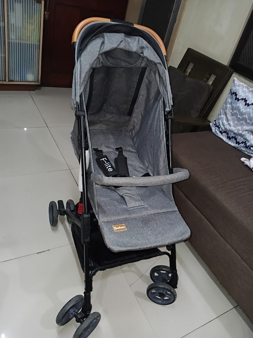 BabyGro F-lite Grey Stroller (Category: Strollers) located in Manila. Submitted by ThrineSo (Listing ID 1453540223, Image 1). Description: - Grey baby stroller - Features a canopy for sun protection - Includes a convenient storage basket - Stylish wooden finish on the handle - Folds compactly for easy storage - Black wheels.
