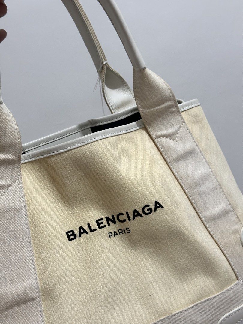 Balenciaga Paris Canvas Tote Bag (Category: Luxury Bags & Wallets) located in Cavite. Submitted by aljennaaaa (Listing ID 1453613932, Image 2). Description: - Brand: Balenciaga - Type: Tote Bag - Color: Cream canvas with white leather trim - Design: Black Balenciaga Paris logo on the front - Features: Top handles, spacious interior - Ideal for: Everyday use, travel - Style: Classic Balenciaga piece.