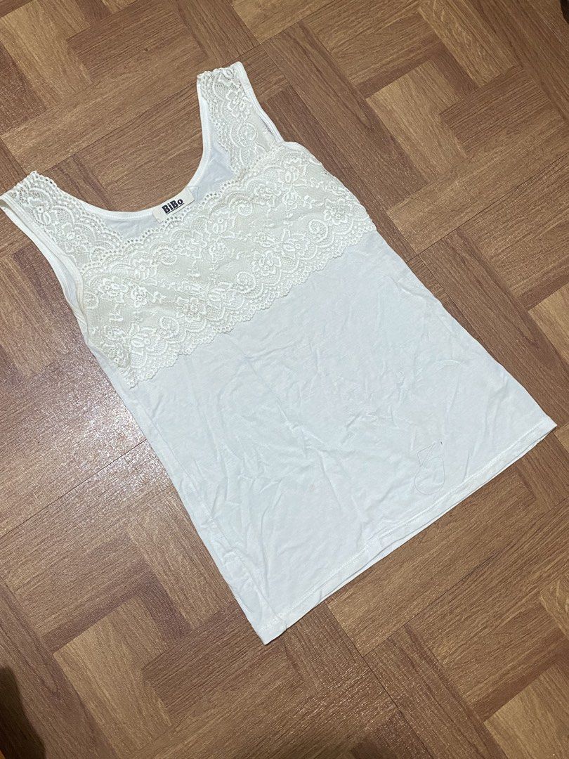 BiBo Ivory Lace Trim Tank Top (Category: Sleeveless) located in Manila. Submitted by mareeya__ (Listing ID 1453614255, Image 2). Description: - length: 21.5 in - Width: 14.5 in - Features pretty lace trim across chest area - Great for layering or wearing alone .