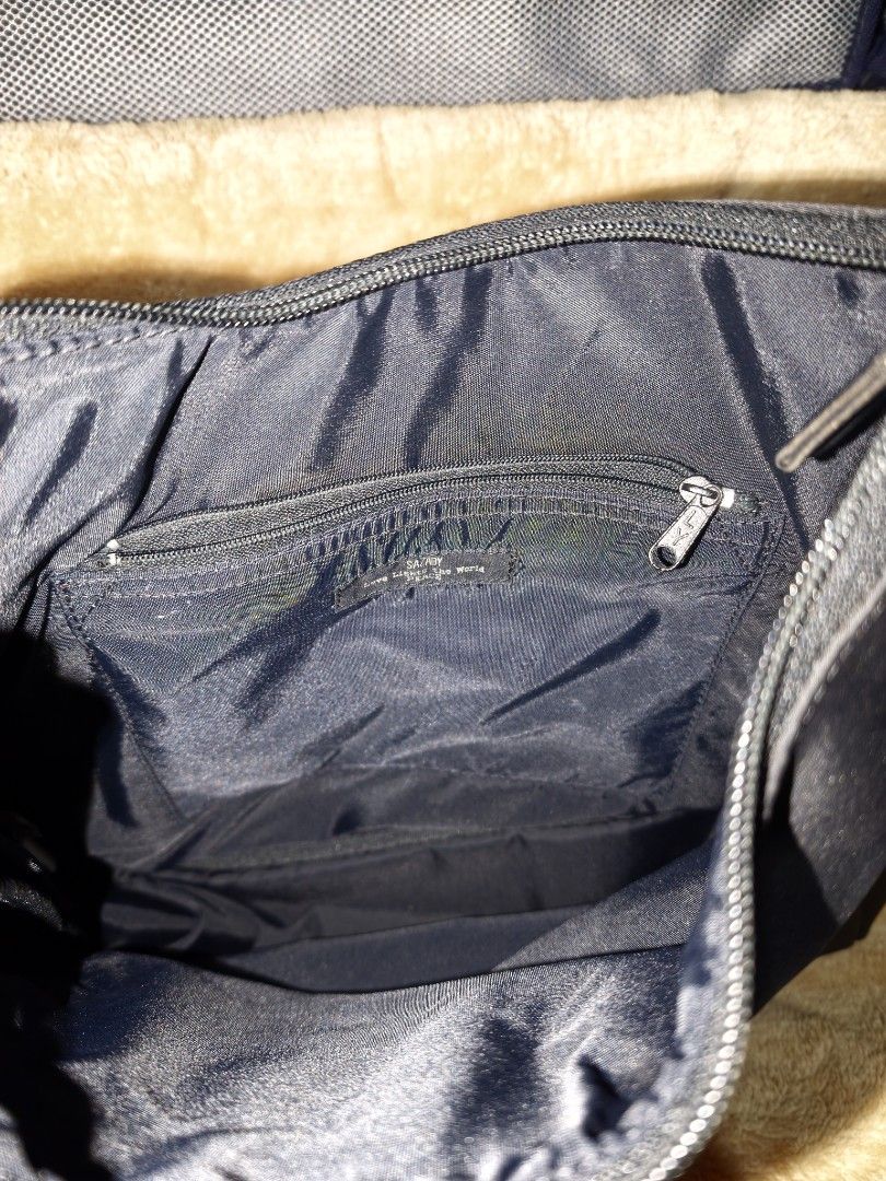 Black Nylon Shoulder Bag with Patent Straps (Category: Shoulder Bags) located in Tanza. Submitted by declutterolshoppe (Listing ID 1453528199, Image 3). Description: - Classic black shoulder bag - Durable nylon material - Shiny patent leather straps - Secure zipper closure - Interior zippered pocket - Ideal for everyday use - Simple and functional design.