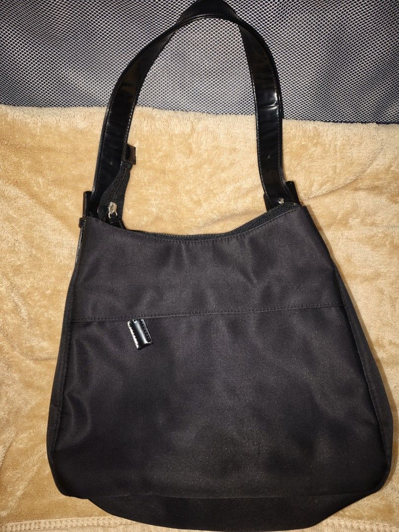 Black Nylon Shoulder Bag with Patent Straps (Category: Shoulder Bags) located in Tanza. Submitted by declutterolshoppe (Listing ID 1453528199, Image 2). Description: - Classic black shoulder bag - Durable nylon material - Shiny patent leather straps - Secure zipper closure - Interior zippered pocket - Ideal for everyday use - Simple and functional design.