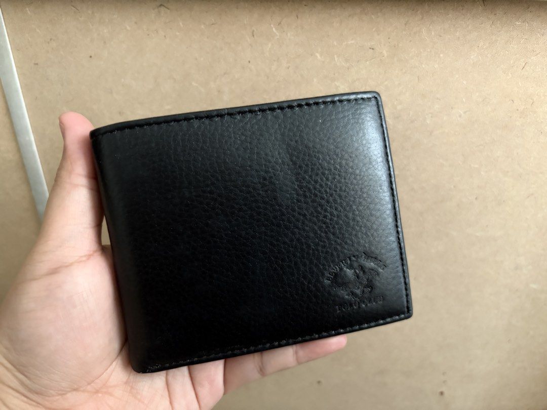 Black Polo Club Bifold Wallet (Category: Wallets & Card Holders) located in Tanza. Submitted by iamdhana (Listing ID 1453539363, Image 1). Description: - Classic black bifold wallet - Made of textured leather - Multiple card slots for ample storage - Clear ID window for easy access - Simple and functional design - Ideal for everyday use.