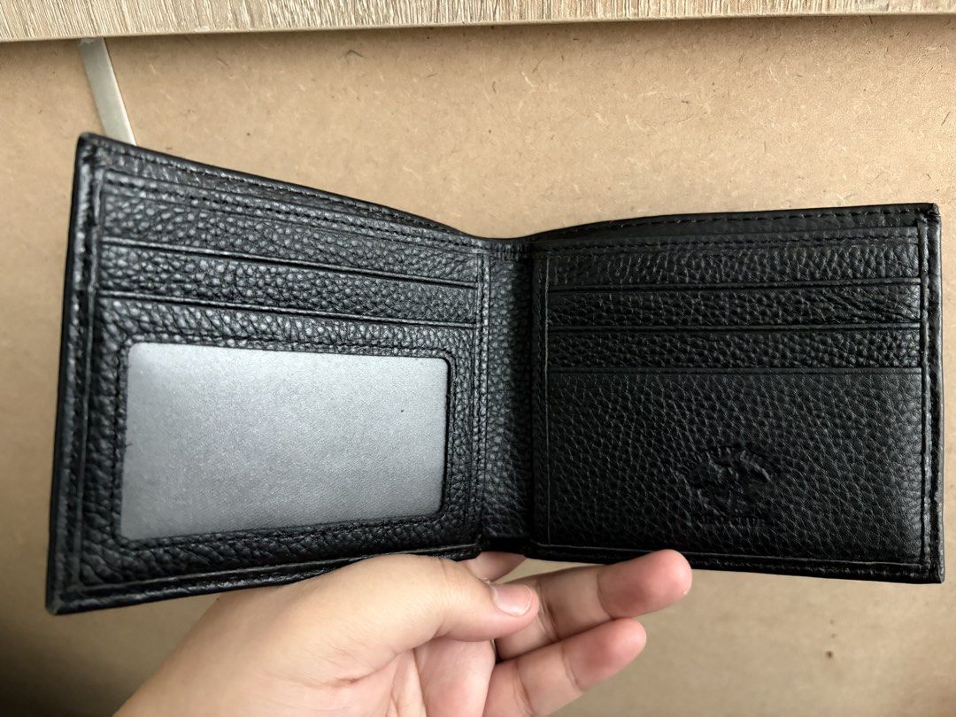 Black Polo Club Bifold Wallet (Category: Wallets & Card Holders) located in Tanza. Submitted by iamdhana (Listing ID 1453539363, Image 2). Description: - Classic black bifold wallet - Made of textured leather - Multiple card slots for ample storage - Clear ID window for easy access - Simple and functional design - Ideal for everyday use.