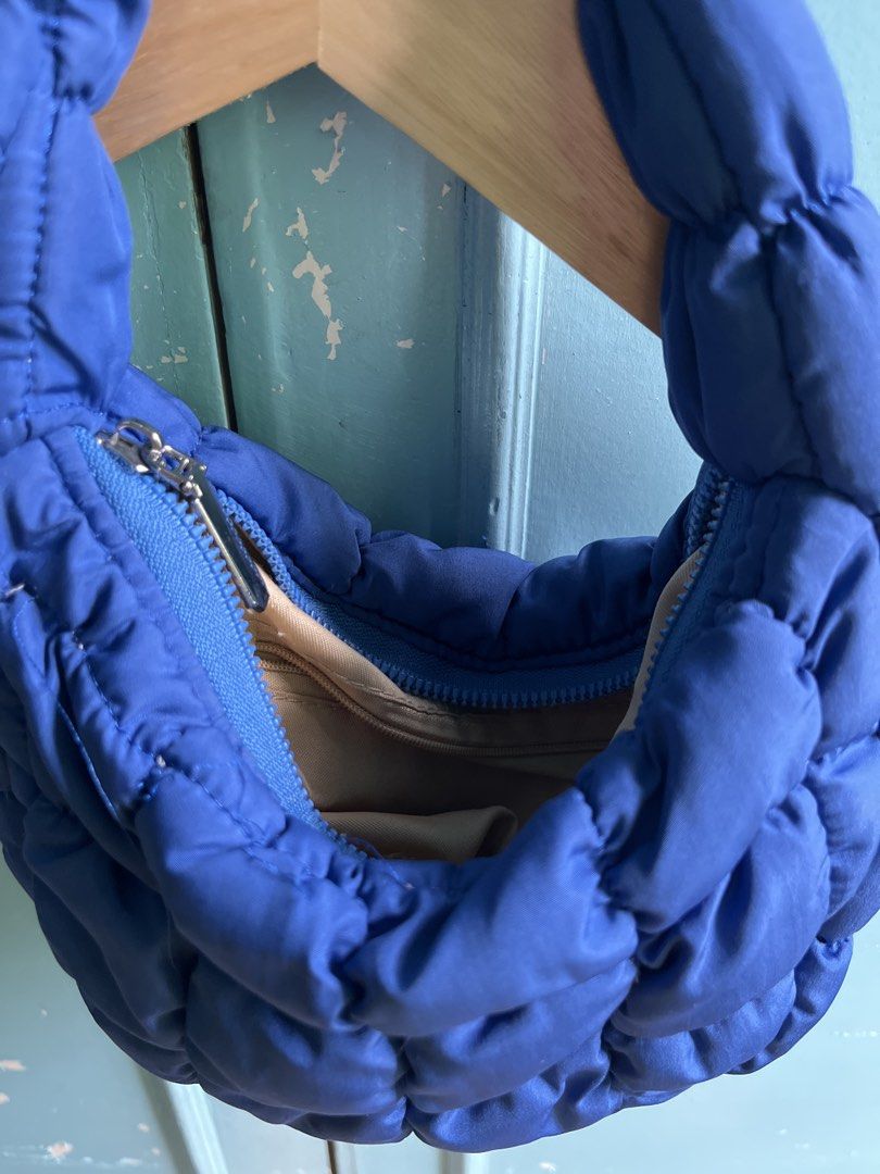 Blue Padded Crescent Shoulder Bag (Category: Shoulder Bags) located in San Juan City. Submitted by superash (Listing ID 1453440855, Image 2). Description: - Adorable blue padded bag - Unique crescent shape - Soft and squishy puffy material - Secure zipper closure - Ideal for everyday or evening use - Fits your essentials.