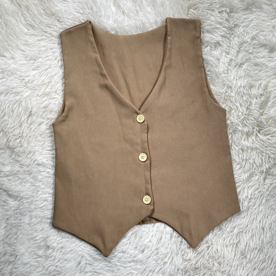 Brown V-Neck Button-Up Vest (Category: Vests) located in Manila. Submitted by kyleeee.mrr (Listing ID 1453573742, Image 1). Description: SMALL TO MED WOVEN FABRIC (double lining) - Simple brown vest - V-neckline with three button closures - Lightweight material, ideal for layering - Versatile piece for various outfits - Please check photos for detailed condition.