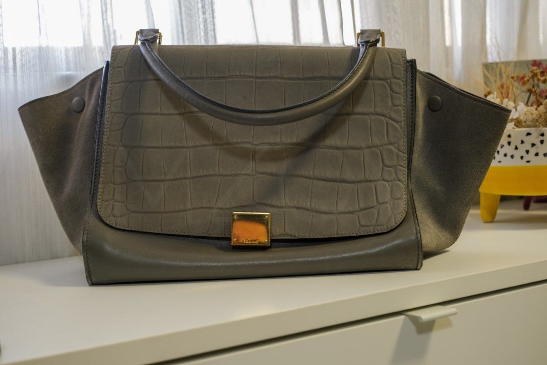 Celine Grey Crocodile Embossed Leather Suede Bag (Category: Luxury Bags & Wallets) located in Santa Rosa. Submitted by jolels (Listing ID 1453482042, Image 1). Description: Celine trapeze Grey Medium Size : 30 x 22 x 15 cm Strap : Available (Non-adjustable) Strap Drop Length : 35 cm Skin : Calfskin, Croc embossed Colour : Grey New : 93% No inclusions.