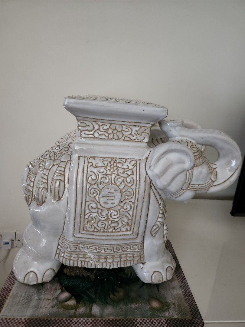 Ceramic Stool / Table (Category: Pots & Planters) located in Singapore. Submitted by moving_2026 (Listing ID 1453486829, Image 1). Description: - White ceramic elephant stool - Features intricate, detailed carvings - Versatile use: decorative accent, side table - Adds a unique touch to any space - sold as a pair. one has one crack line repaired..