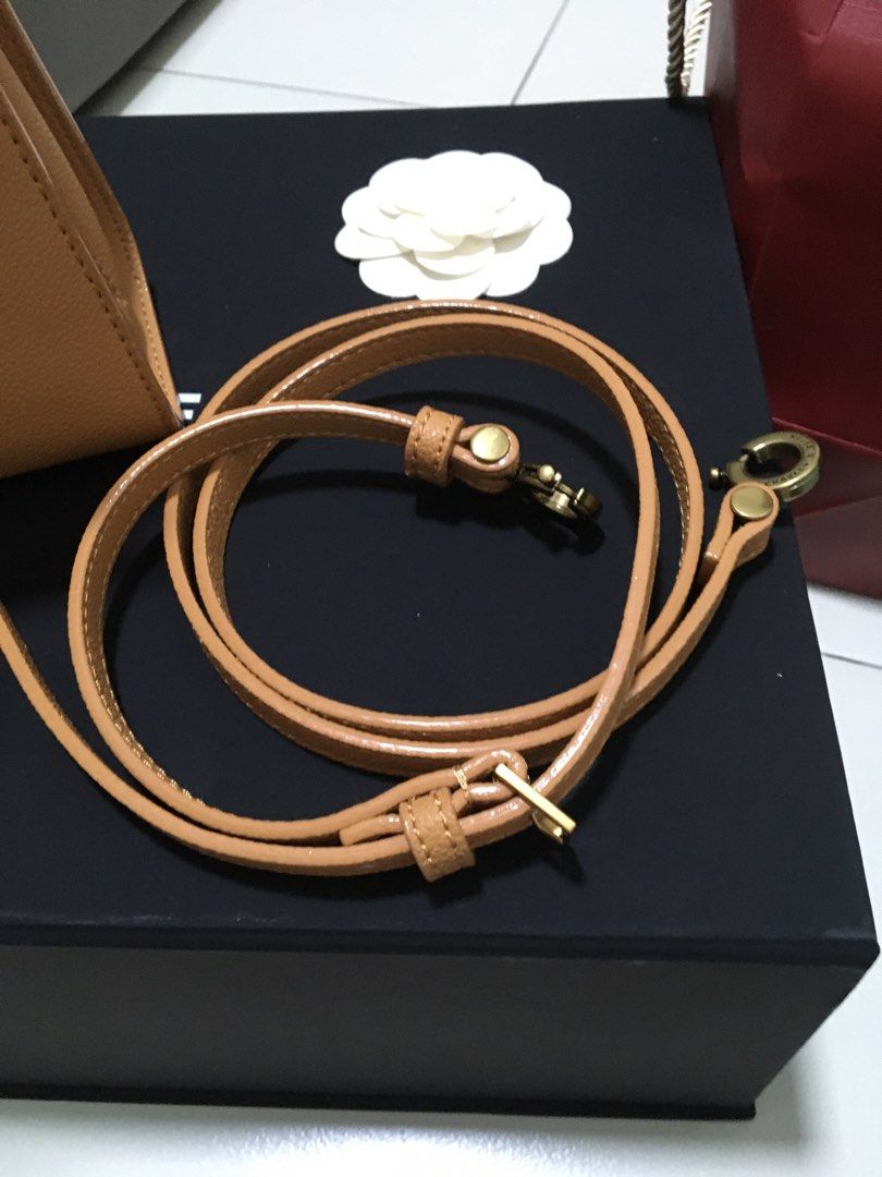 Charles & Keith Tan Top Handle Bag with Sling Strap (Category: Cross-body Bags) located in Quezon City. Submitted by simple_precious (Listing ID 1453475304, Image 3). Description: - Brand: Charles & Keith - Color: Tan - Style: Top handle bag - Features: Detachable sling strap, gold hardware, secure clasp closure - Includes: Original dust bag - Versatile: Suitable for everyday or special occasions Never used.