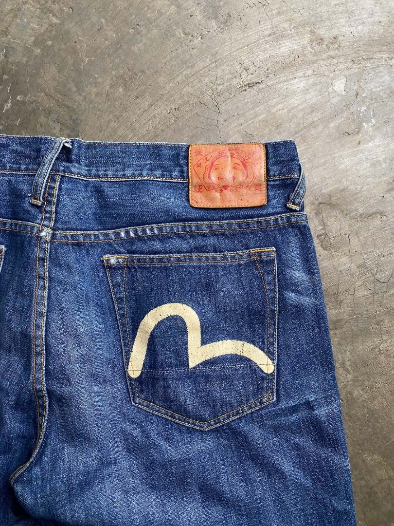 EVISU GENES Denim Jeans with Seagull Logo (Category: Jeans) located in Cabanatuan. Submitted by vivian_nicole_03 (Listing ID 1453536729, Image 3). Description: - Classic blue denim jeans from EVISU GENES - Features iconic white seagull logo on back pockets - Size 34 - Button fly closure - Minor distressing on the front - Perfect for everyday wear.