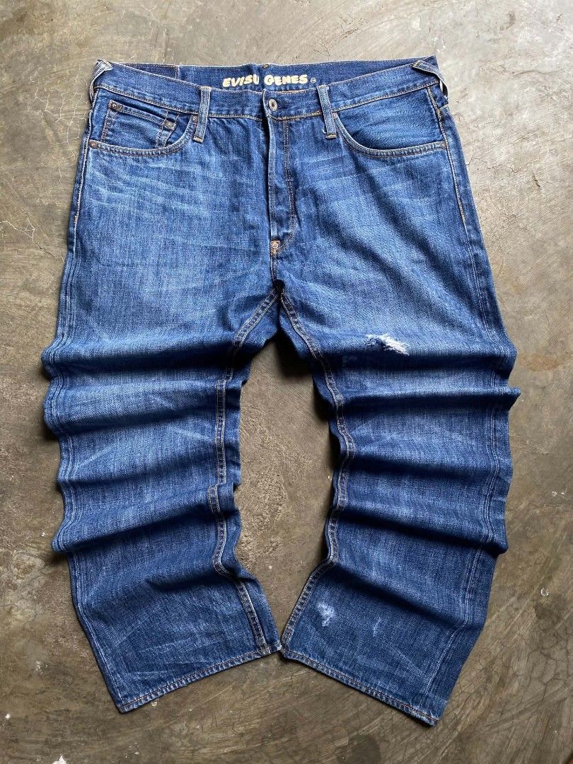 EVISU GENES Denim Jeans with Seagull Logo (Category: Jeans) located in Cabanatuan. Submitted by vivian_nicole_03 (Listing ID 1453536729, Image 2). Description: - Classic blue denim jeans from EVISU GENES - Features iconic white seagull logo on back pockets - Size 34 - Button fly closure - Minor distressing on the front - Perfect for everyday wear.