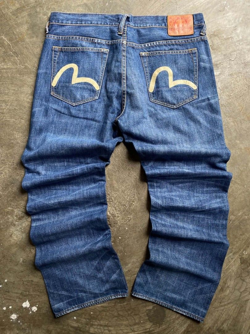 EVISU GENES Denim Jeans with Seagull Logo (Category: Jeans) located in Cabanatuan. Submitted by vivian_nicole_03 (Listing ID 1453536729, Image 1). Description: - Classic blue denim jeans from EVISU GENES - Features iconic white seagull logo on back pockets - Size 34 - Button fly closure - Minor distressing on the front - Perfect for everyday wear.