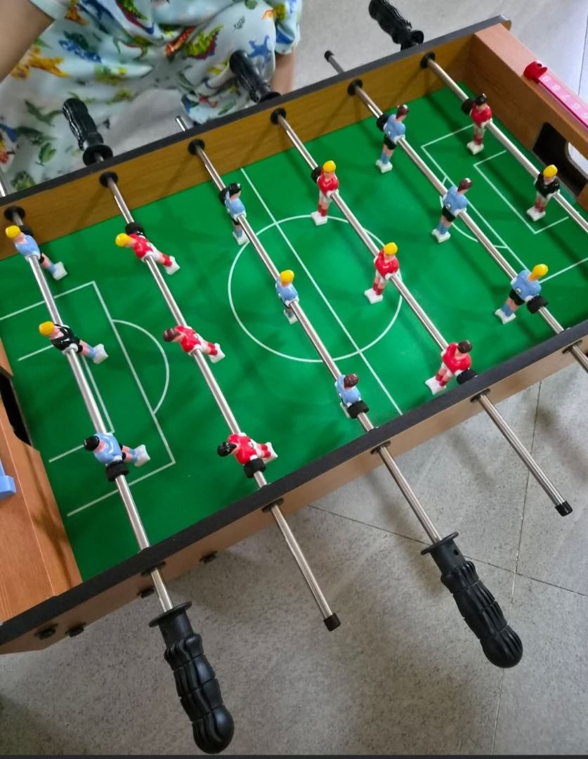 Flying Tiger Tabletop Foosball (Category: Board Games & Puzzles) located in Tanza. Submitted by mama_1996sagi (Listing ID 1453620328, Image 2). Description: - Flying Tiger Tabletop Foosball game - Compact and portable design - Features a vibrant green playing field - Includes colorful player figures - Sturdy rods for smooth gameplay - Perfect for indoor fun and quick matches.