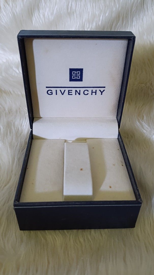 Givenchy Jewelry Box (Category: Accessory Holder, Box & Organizers) located in Gingoog City. Submitted by ThePurpleBox (Listing ID 1453439865, Image 3). Description: - Authentic Givenchy box - Color: Dark blue exterior with white Givenchy logo and emblem - Interior: Lined with white material - Perfect for storing small jewelry, trinkets, or as a gift.