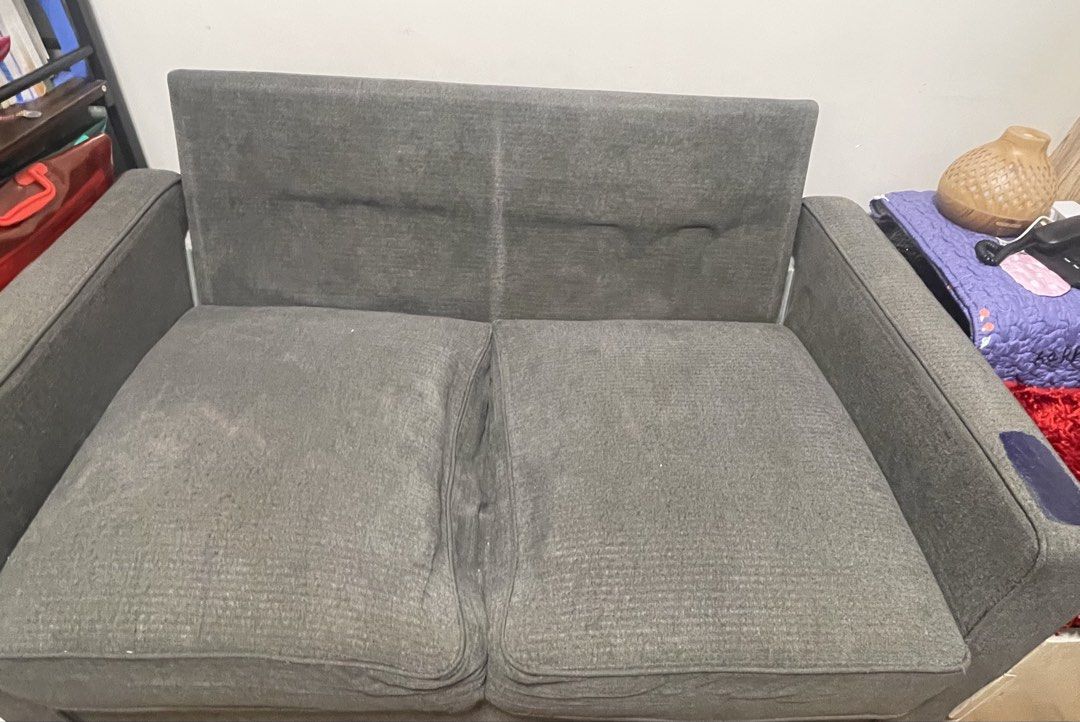Grey 2-Seater Sofa (Category: Sofas) located in Makati City. Submitted by loushhh (Listing ID 1453519803, Image 1). Description: - Grey 2-seater sofa - Fabric upholstery - Removable cushions - Ideal for small spaces - Minor marks on fabric (please check photos) - Sturdy and functional.