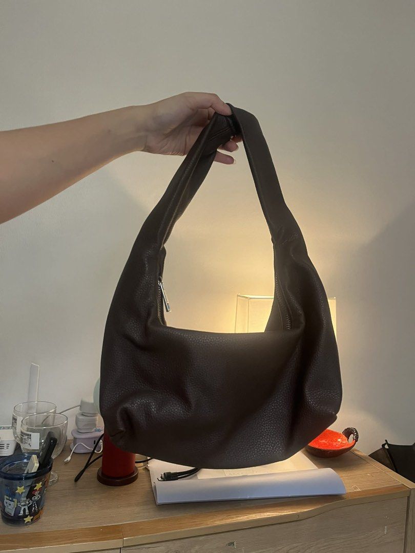 GVN Mini Brown Hobo Bag in Espresso (Category: Shoulder Bags) located in Quezon City. Submitted by thriftwithgabe (Listing ID 1453596244, Image 2). Description: - Brand: GVN - Material: Brown Textured Leather - Closure: Zipper at the top - Strap: Single shoulder strap - Interior: Spacious with fabric lining - Style: Minimalist, great for everyday use - Capacity: Fits essentials comfortably -flaw: with chip on the handle.