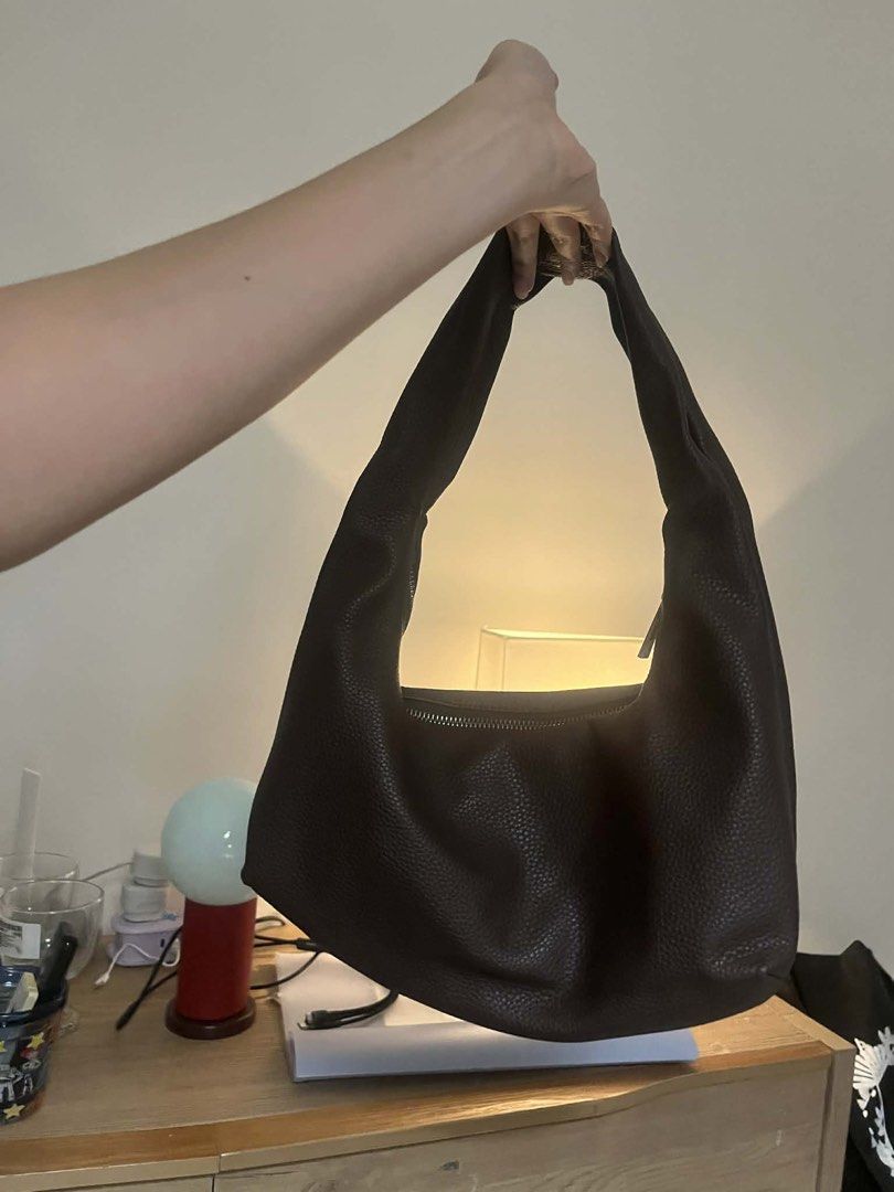 GVN Mini Brown Hobo Bag in Espresso (Category: Shoulder Bags) located in Quezon City. Submitted by thriftwithgabe (Listing ID 1453596244, Image 3). Description: - Brand: GVN - Material: Brown Textured Leather - Closure: Zipper at the top - Strap: Single shoulder strap - Interior: Spacious with fabric lining - Style: Minimalist, great for everyday use - Capacity: Fits essentials comfortably -flaw: with chip on the handle.