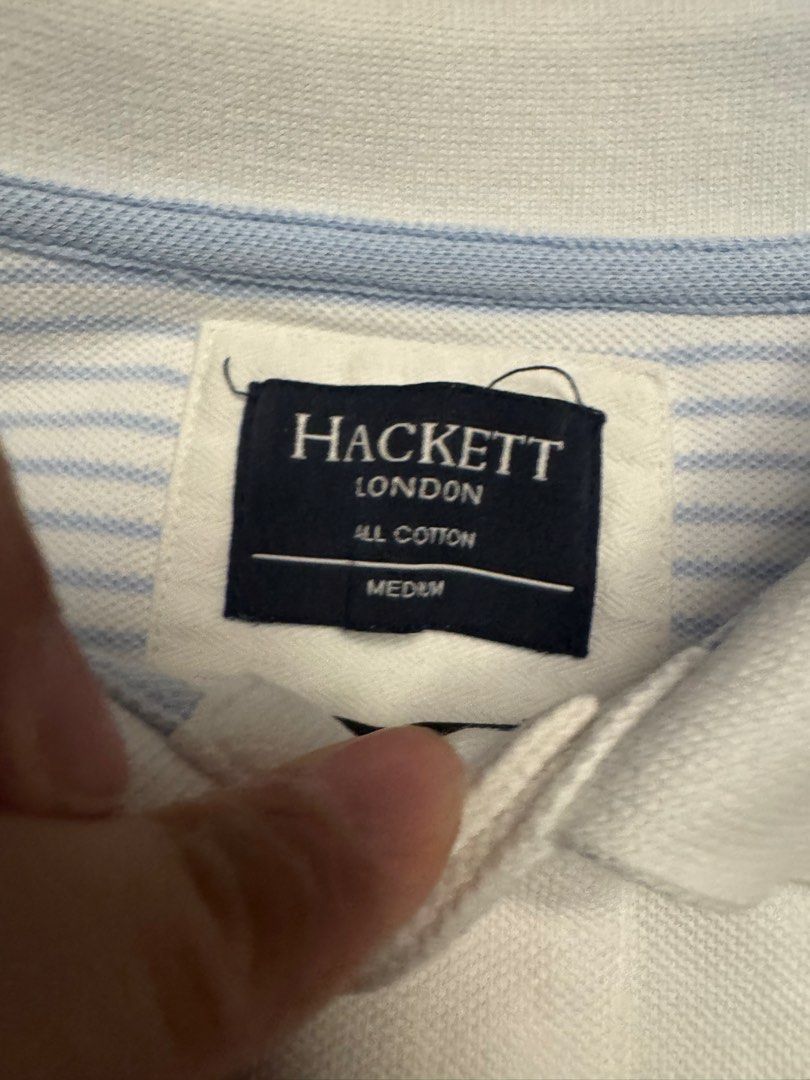 Hackett London White Cotton Polo Shirt Medium (Category: Tshirts & Polo Shirts ) located in Quezon City. Submitted by jamesfon (Listing ID 1453456460, Image 2). Description: - Brand: Hackett London - Color: White - Size: Medium - Material: 100% Cotton - Features: Hackett logo on chest, embroidered logo on back - Design: Classic short-sleeve, two-button placket - Occasion: Casual wear - Authentic.