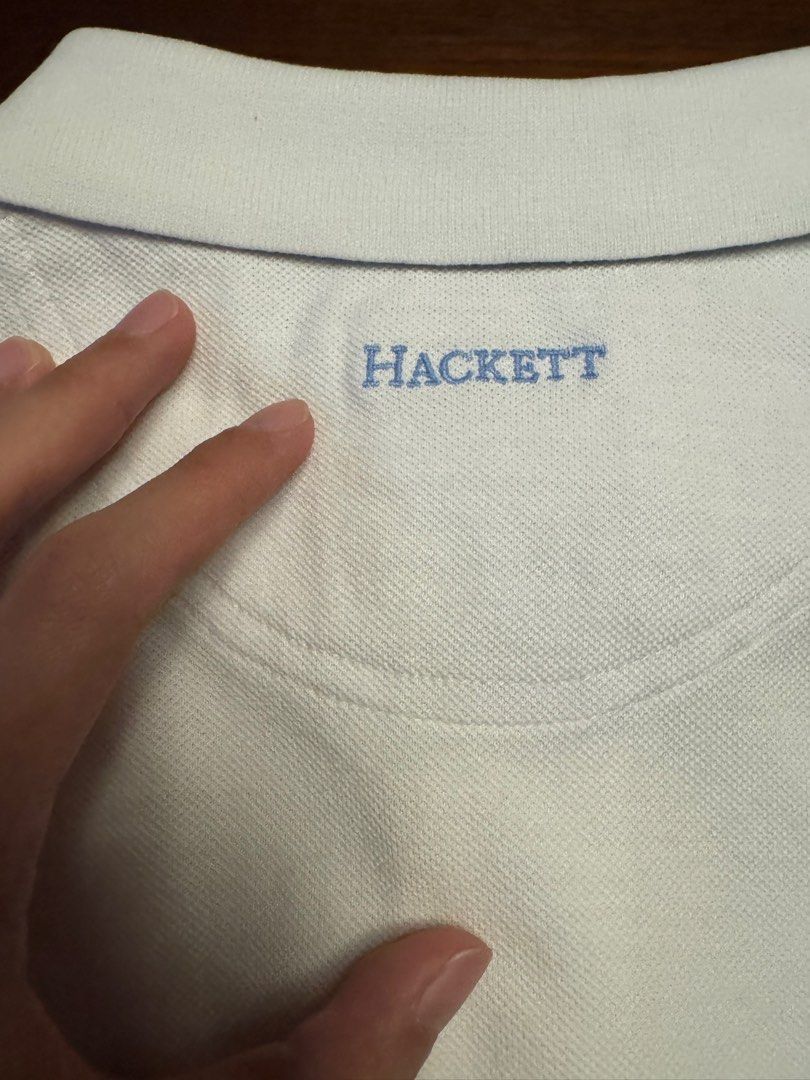 Hackett London White Cotton Polo Shirt Medium (Category: Tshirts & Polo Shirts ) located in Quezon City. Submitted by jamesfon (Listing ID 1453456460, Image 3). Description: - Brand: Hackett London - Color: White - Size: Medium - Material: 100% Cotton - Features: Hackett logo on chest, embroidered logo on back - Design: Classic short-sleeve, two-button placket - Occasion: Casual wear - Authentic.