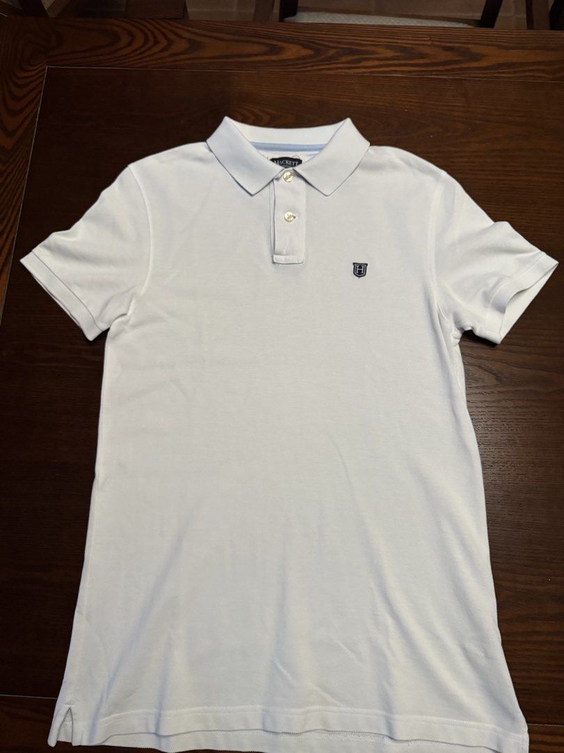 Hackett London White Cotton Polo Shirt Medium (Category: Tshirts & Polo Shirts ) located in Quezon City. Submitted by jamesfon (Listing ID 1453456460, Image 1). Description: - Brand: Hackett London - Color: White - Size: Medium - Material: 100% Cotton - Features: Hackett logo on chest, embroidered logo on back - Design: Classic short-sleeve, two-button placket - Occasion: Casual wear - Authentic.