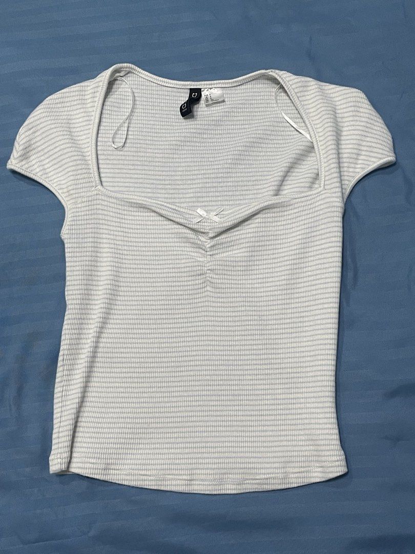 H&M Divided Ribbed Square Neck Top White Blue Stripes Size S (Category: Sleeveless) located in Marikina City. Submitted by flutterchi (Listing ID 1453584009, Image 1). Description: - White ribbed top with subtle thin blue stripes - Flattering square neckline with a sweet front bow detail - Comfortable short cap sleeves - Stretchy material for a great fit - Brand: H&M Divided - rfs: not my style anymore.
