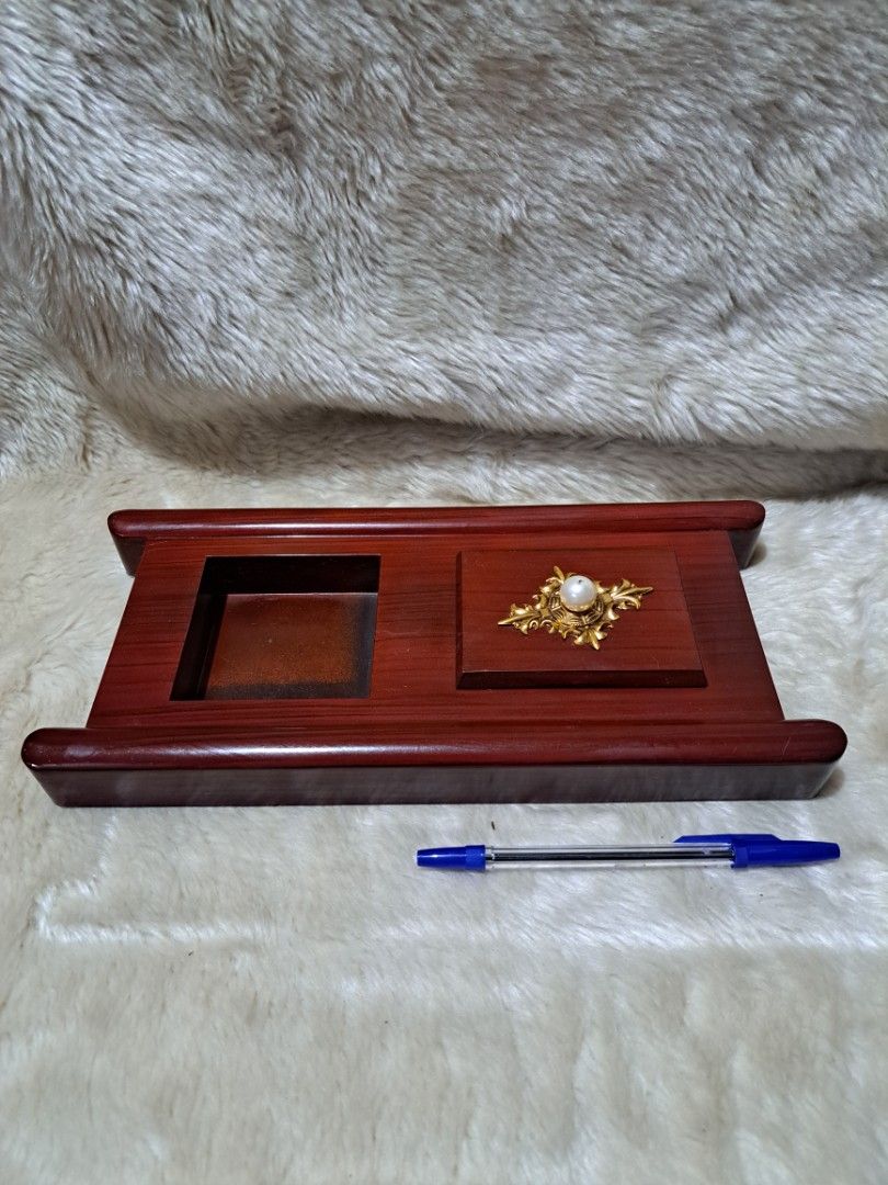 Cigarette Holder with Decorative Top (Category: Home Fragrance) located in Quezon City. Submitted by sbvdmanaog (Listing ID 1453592279, Image 2). Description: - Elegant incense burner - Two compartments for ash catching or incense sticks - Decorative gold accent with a pearl on top - Smooth, nice wood finish - Approximately 8 inches tall - Ideal for your desk or altar.