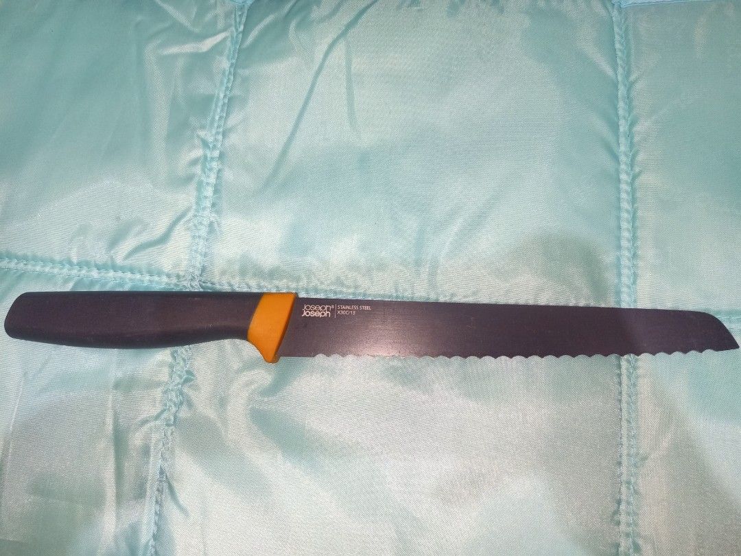 Joseph Joseph Serrated Bread Knife Stainless Steel (Category: Knives & Chopping Boards) located in Pasig City. Submitted by urdal01 (Listing ID 1453588629, Image 2). Description: - Joseph Joseph Bread Knife - Serrated stainless steel blade (approx. 8 inches) - Features a stylish orange handle accent - Perfect for slicing bread and pastries.