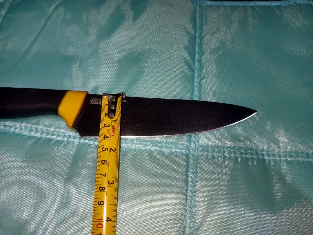 Joseph Joseph Stainless Steel Chef's Knife (Category: Knives & Chopping Boards) located in Pasig City. Submitted by urdal01 (Listing ID 1453585472, Image 3). Description: - Joseph Joseph Chef's Knife - 8-inch Stainless Steel Blade - Black Handle with Yellow Accent - Handle marked with '1' - Ideal for Everyday Kitchen Tasks - Blade shows some signs of use.