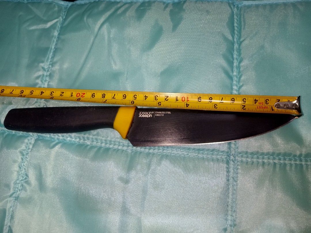 Joseph Joseph Stainless Steel Chef's Knife (Category: Knives & Chopping Boards) located in Pasig City. Submitted by urdal01 (Listing ID 1453585472, Image 2). Description: - Joseph Joseph Chef's Knife - 8-inch Stainless Steel Blade - Black Handle with Yellow Accent - Handle marked with '1' - Ideal for Everyday Kitchen Tasks - Blade shows some signs of use.