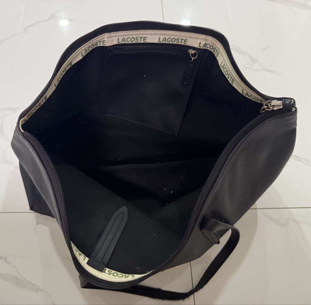 Authentic Lacoste Black Tote Bag (Category: Tote Bags) located in Las Pinas. Submitted by vanethneth (Listing ID 1453520787, Image 3). Description: - Classic black Lacoste tote bag - Spacious interior for essentials - Secure zipper closure - Iconic Lacoste crocodile logo on front - Ideal for everyday use or travel - Authentic.