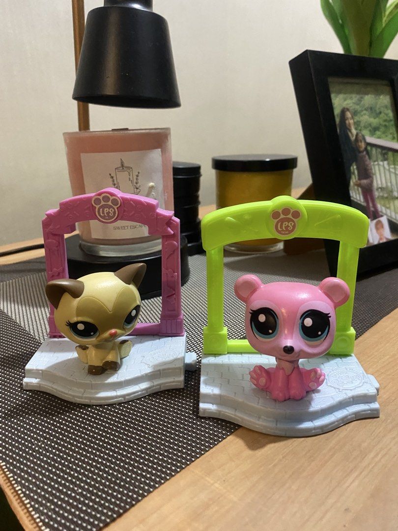 Littlest Pet Shop LPS Figures - Cat and Bear (Category: Figurines & Statues) located in Manila. Submitted by mommymaal (Listing ID 1453552586, Image 1). Description: - Two adorable Littlest Pet Shop figures included. - Features a tan cat with brown accents and a sweet pink bear. - Both pets have large, expressive eyes. - Comes with colorful, individual stands for display. - Part of the sought-after LPS Sweet Escape series. - Perfect for collector