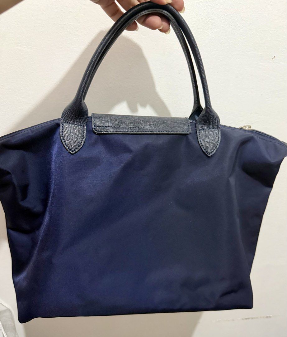 LONGCHAMP Le Pliage Neo Medium Top Handle Handbag - Navy (Category: Luxury Bags & Wallets) located in Muntinlupa City. Submitted by bashabells (Listing ID 1453603927, Image 3). Description: - Authentic Navy blue Longchamp Le Pliage bag - Long strap is included - Spacious interior, ideal for weekend getaways or everyday essentials - Free felt base shaper - Still for sale at zalora.