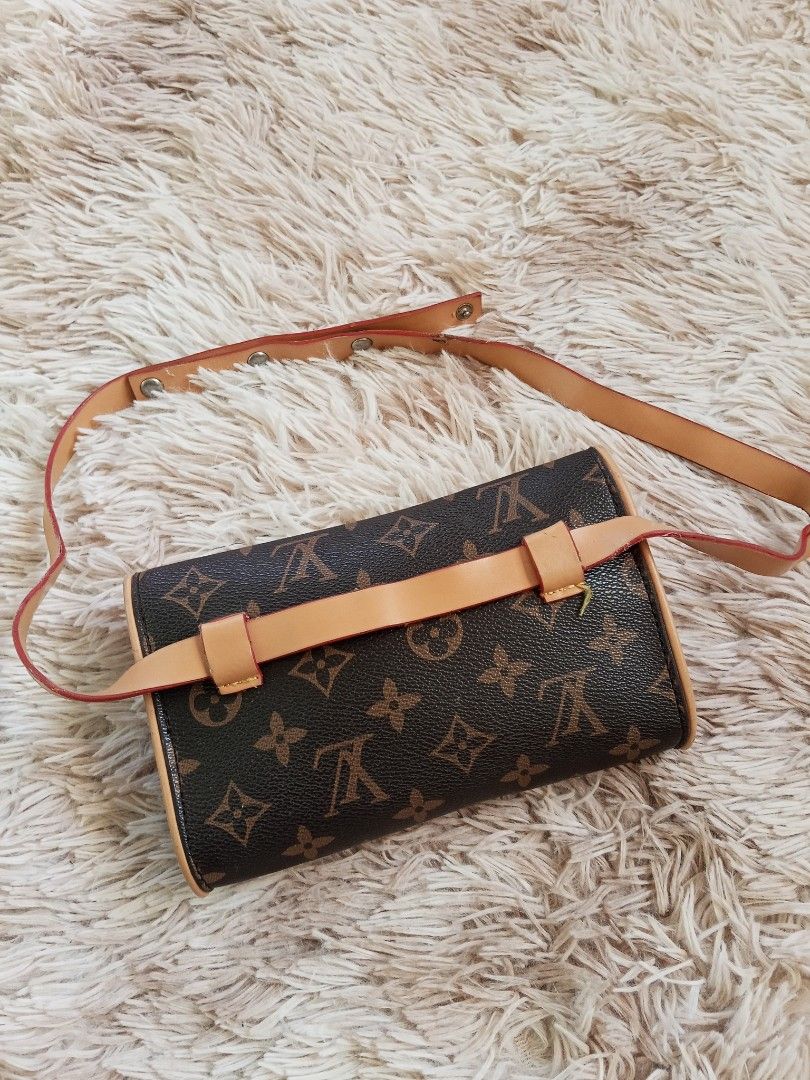 Louis Vuitton Monogram Canvas Waist Bag Pouch (Category: Luxury Bags & Wallets) located in Zamboanga. Submitted by reg_ukay_shopp (Listing ID 1453511312, Image 2). Description: - Features tan leather trim and adjustable strap. - Secure magnetic snap closure. - Interior lined with durable brown fabric. - Bag edges exhibit some signs of use. - Ideal for convenient, hands-free carrying..
