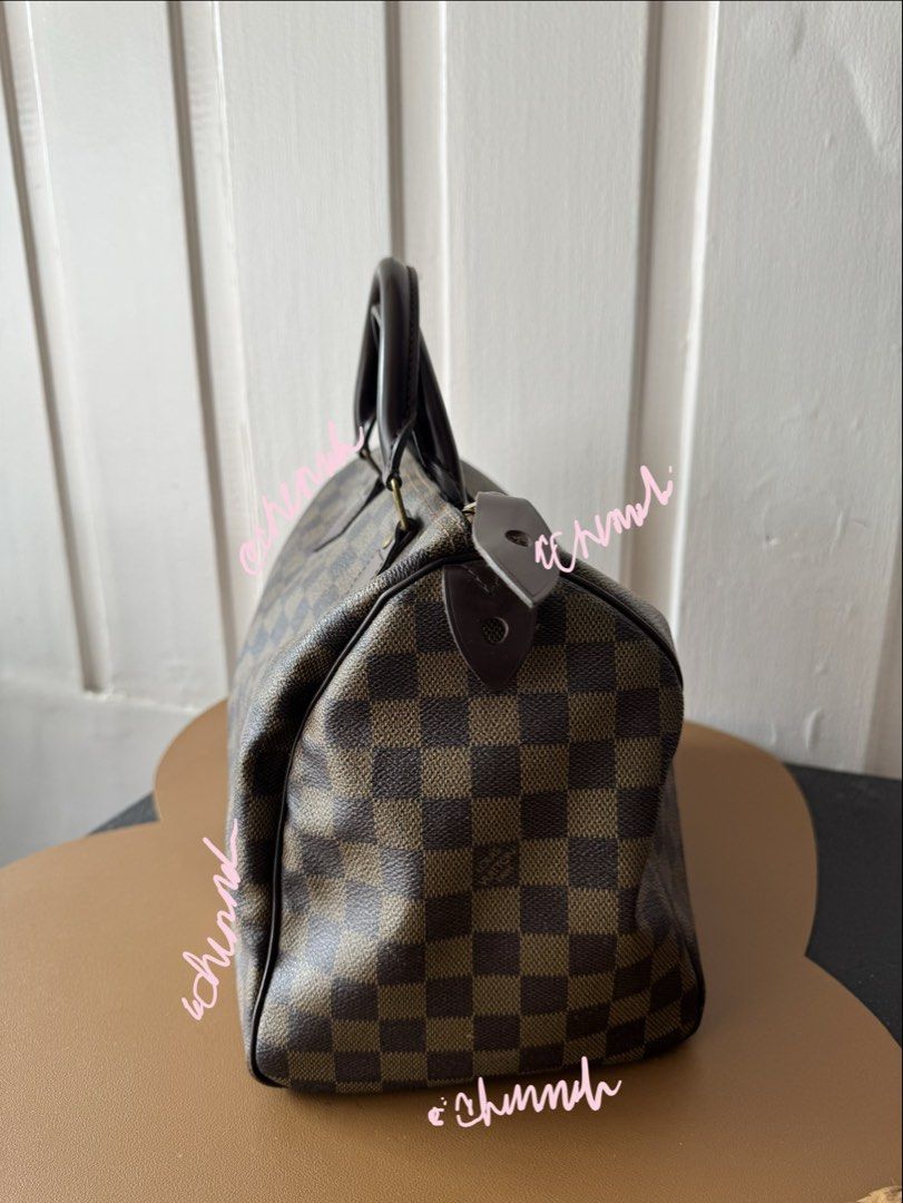 Louis Vuitton Speedy Damier Ebene Canvas Handbag (Category: Luxury Bags & Wallets) located in Pasig City. Submitted by jennasantos (Listing ID 1453442482, Image 3). Description: - Authentic Classic Louis Vuitton Speedy bag - Damier Ebene canvas with iconic checkered pattern - Genuine leather handles and trim - Secure zipper closure - Spacious red interior lining - Ideal for everyday use Shipping from Pasig - fee to be shouldered by buyer Shipping
