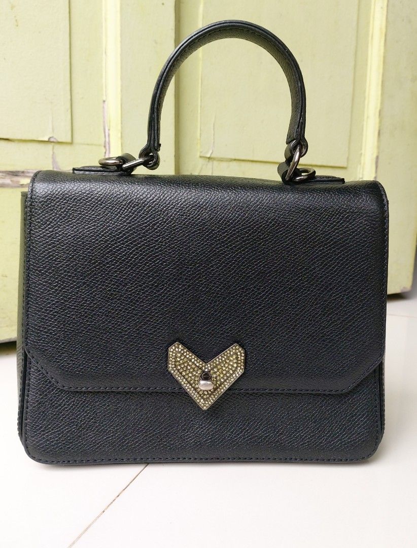 Lovcat Paris Top handle bag with Heart Clasp (Category: Luxury Bags & Wallets) located in Lapu Lapu. Submitted by agnesapm_29813 (Listing ID 1453563709, Image 1). Description: - Black textured leather handbag - Cute heart-shaped clasp with rhinestones - Top handle for carrying - Simple and chic design - Versatile: good for everyday or special occasions - Clean interior - Measurements: width-8.5 inches, height-6.5 inches.