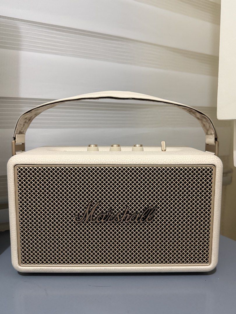 Marshall Kilburn III (Category: Soundbars, Speakers & Amplifiers) located in Quezon City. Submitted by annpy (Listing ID 1453583109, Image 1). Description: - Cream colored Marshall Kilburn III speaker - Portable design with a comfortable leather handle - Easy-to-use controls on top: volume, bass, and treble - Convenient aux input and USB charging port - Delivers impressive sound quality for its compact size - Ideal for enjoying music on the go Co