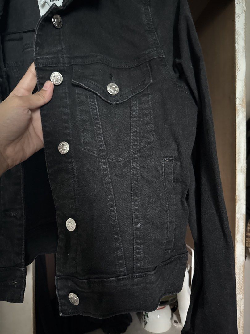 MNG Black Denim Jacket (Category: Coats, Jackets and Outerwear) located in Manila. Submitted by declutterwidme (Listing ID 1453439274, Image 3). Description: - Classic black denim jacket from MNG - Button-up front - Two chest pockets - Long sleeves with button cuffs - Essential wardrobe staple, easy to style.