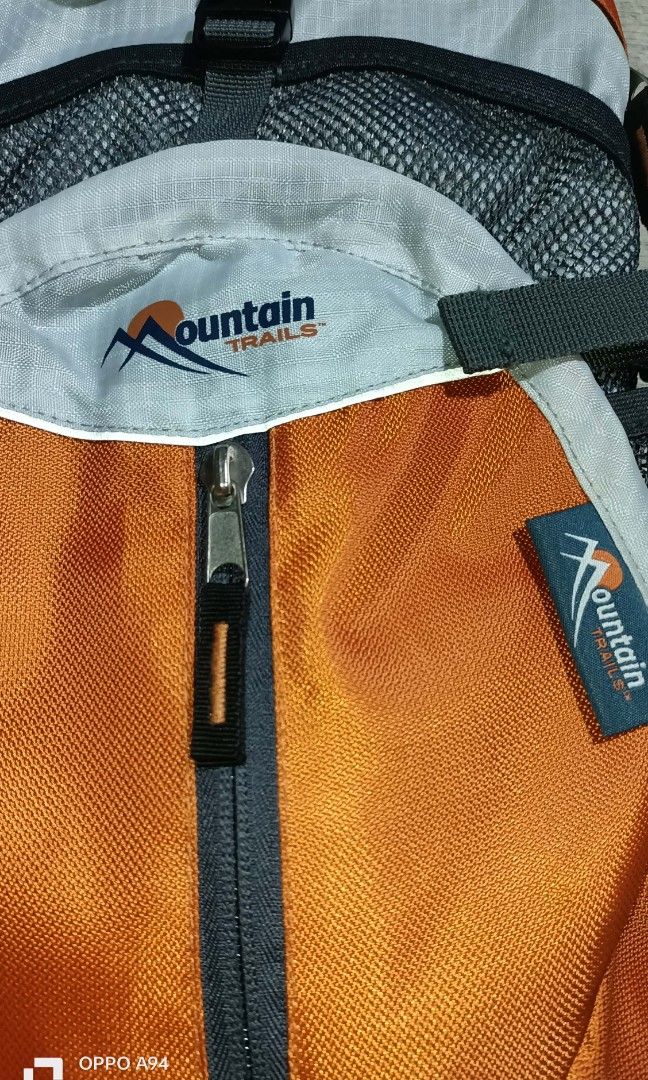 Mountain trails hydration pack (Category: Bicycles) located in Quezon City. Submitted by Bernz (Listing ID 1453557879, Image 2). Description: The selected item is a Mountain Trails Revive 12 Hydration Pack with a 2-liter capacity. [1] Key Features & Design Hydration-Ready: Features a specialized compartment designed to hold a 2-liter water bladder.Material & Structure: Built with an orange and grey ripstop fabric layout alongside ventilated mesh 