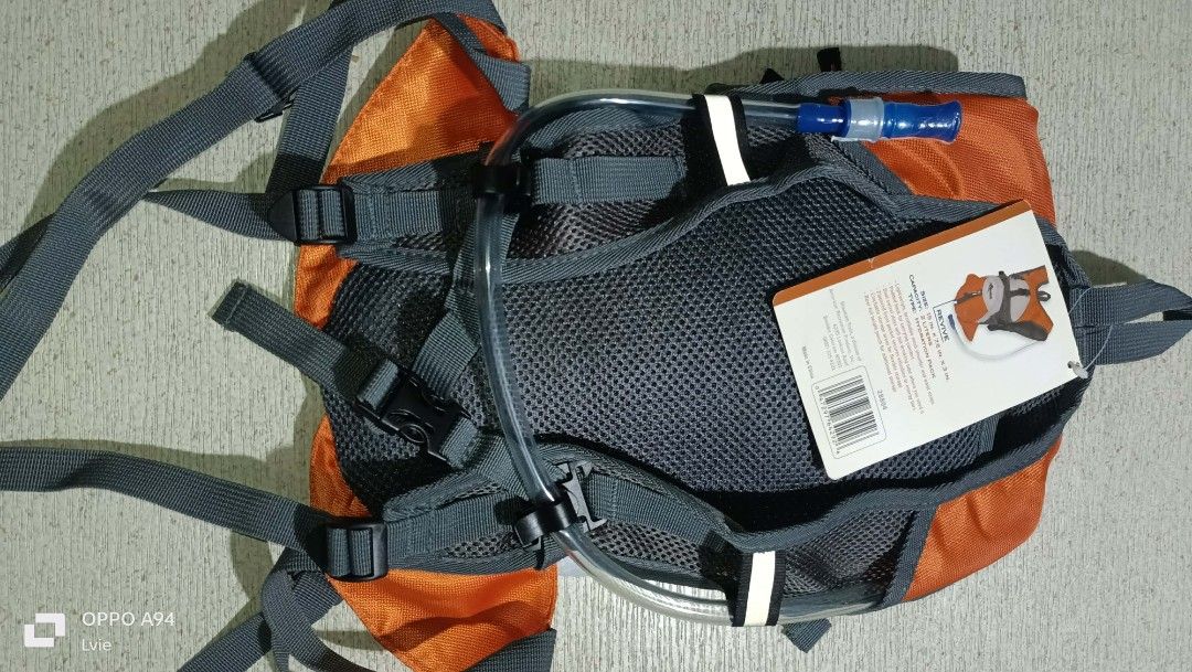 Mountain trails hydration pack (Category: Bicycles) located in Quezon City. Submitted by Bernz (Listing ID 1453557879, Image 3). Description: The selected item is a Mountain Trails Revive 12 Hydration Pack with a 2-liter capacity. [1] Key Features & Design Hydration-Ready: Features a specialized compartment designed to hold a 2-liter water bladder.Material & Structure: Built with an orange and grey ripstop fabric layout alongside ventilated mesh 