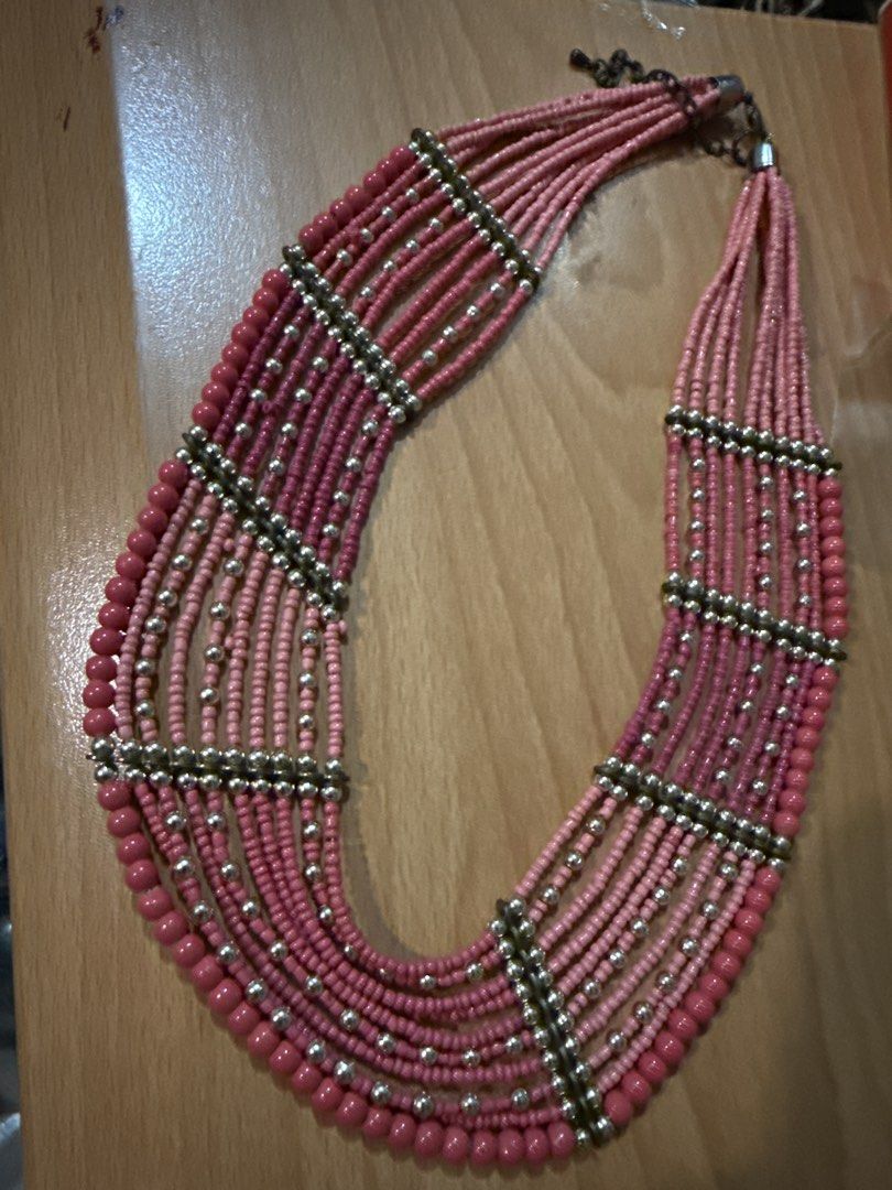 Multi-strand Pink Beaded Necklace with Silver Accents (Category: Necklaces) located in Manila. Submitted by eicho (Listing ID 1453594501, Image 1). Description: - Chunky multi-strand necklace - Features various shades of pink beads - Accented with small silver beads between strands - Secure clasp closure - Perfect statement piece for any outfit - Unique design.