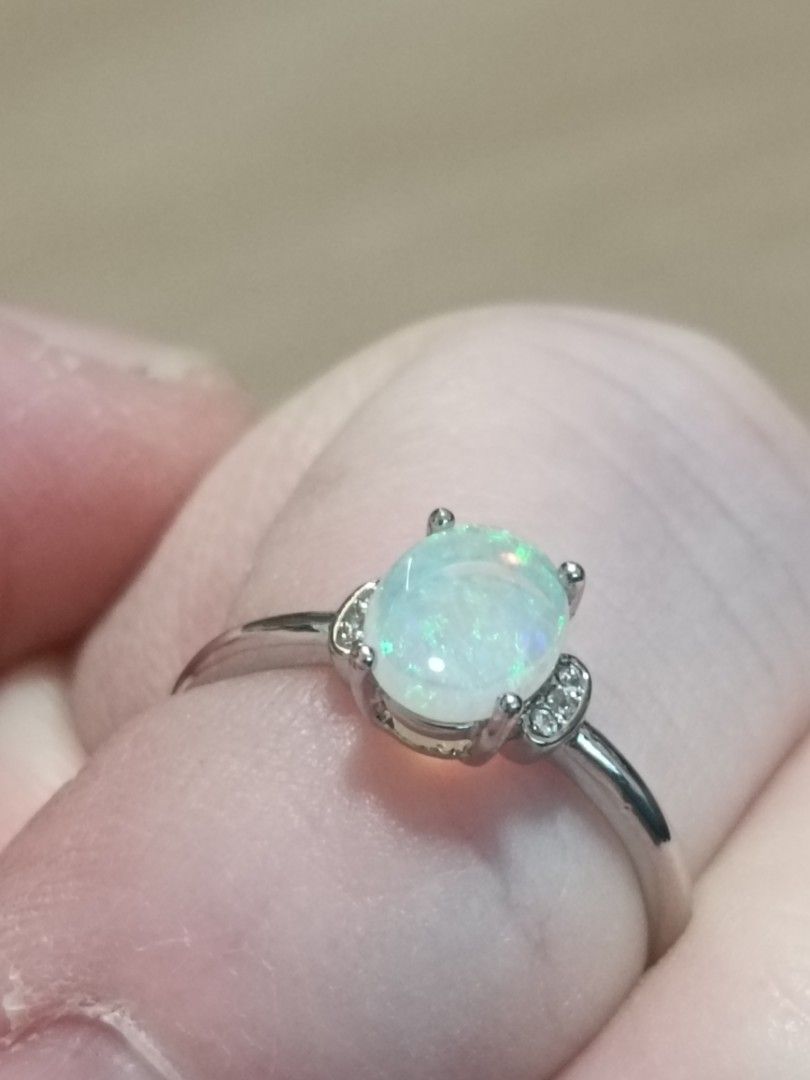 Opal (Category: Rings) located in Singapore. Submitted by subaru2.0 (Listing ID 1453523163, Image 3). Description: - Captivating opal gemstone with iridescent shimmer - Elegant silver-plated band - Accented with small sparkling stones on the sides - Perfect for adding a touch of elegance - Suitable for everyday wear or as a gift - Meetup available at Blk 442B Bukit Batok West Ave 8.