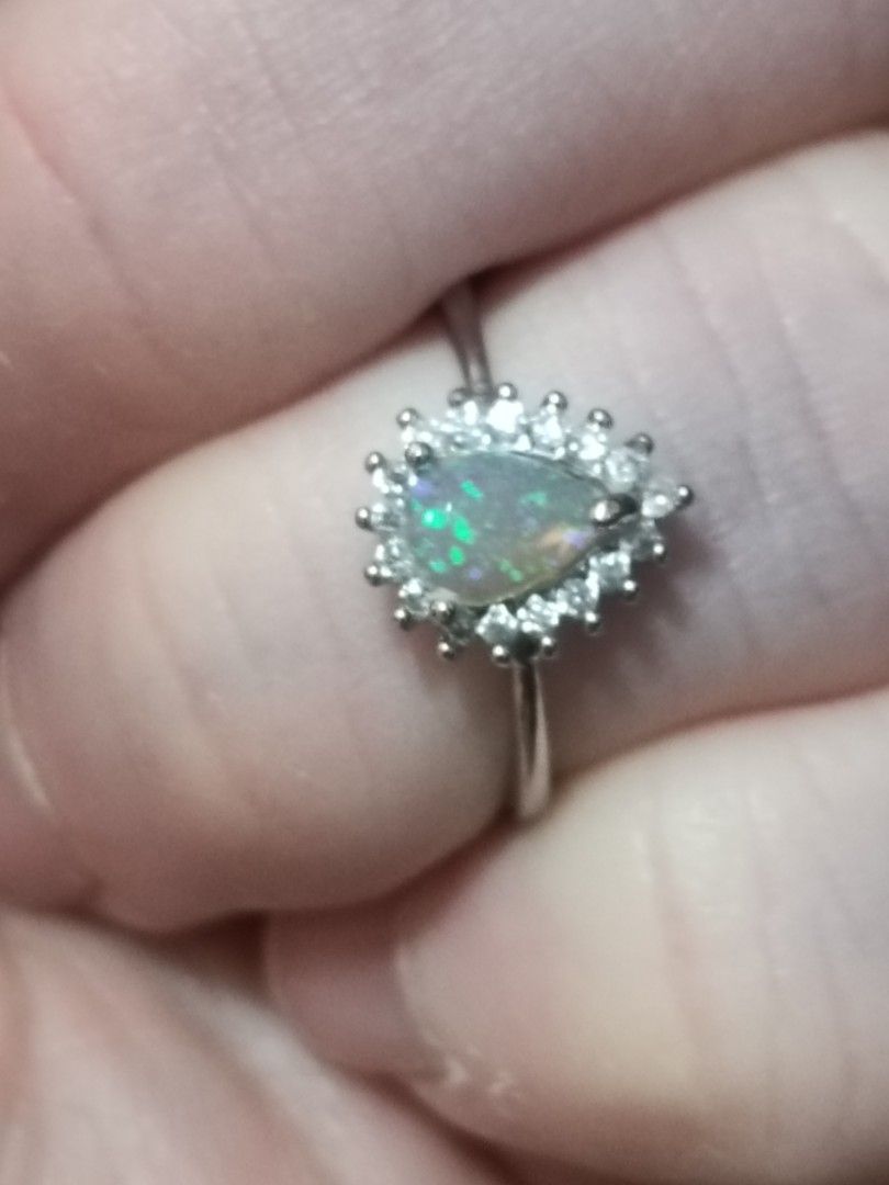 Opal ring (Category: Rings) located in Singapore. Submitted by subaru2.0 (Listing ID 1453522529, Image 2). Description: - Features a pear-shaped opal gemstone set in silver plated setting - Surrounded by a halo of smaller, sparkling stones. - Opal displays a beautiful play of colors. - Elegant and eye-catching design. - Ideal for everyday wear or special occasions..