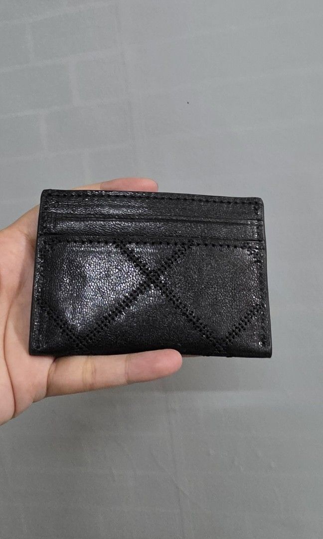 Original Tory Burch Black Quilted Leather Cardholder (Category: Wallets & Card holders) located in Pasig City. Submitted by lfboutique (Listing ID 1453148789, Image 3). Description: - Tory Burch black quilted leather cardholder no cod pasig loc original and bnew no inclusion thus selling low - Iconic gold-tone logo hardware - Multiple card slots for organization - Compact and stylish for everyday use - Perfect for keeping essential cards handy.