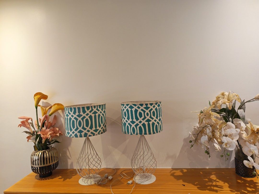 Pair of Geometric Pattern Table Lamps (Category: Lighting) located in Las Pinas. Submitted by zealstone.eb5a04 (Listing ID 1453618003, Image 1). Description: - Set of 2 table lamps - White wire base - Teal and white geometric patterned shades - Functional and stylish addition to any room.
