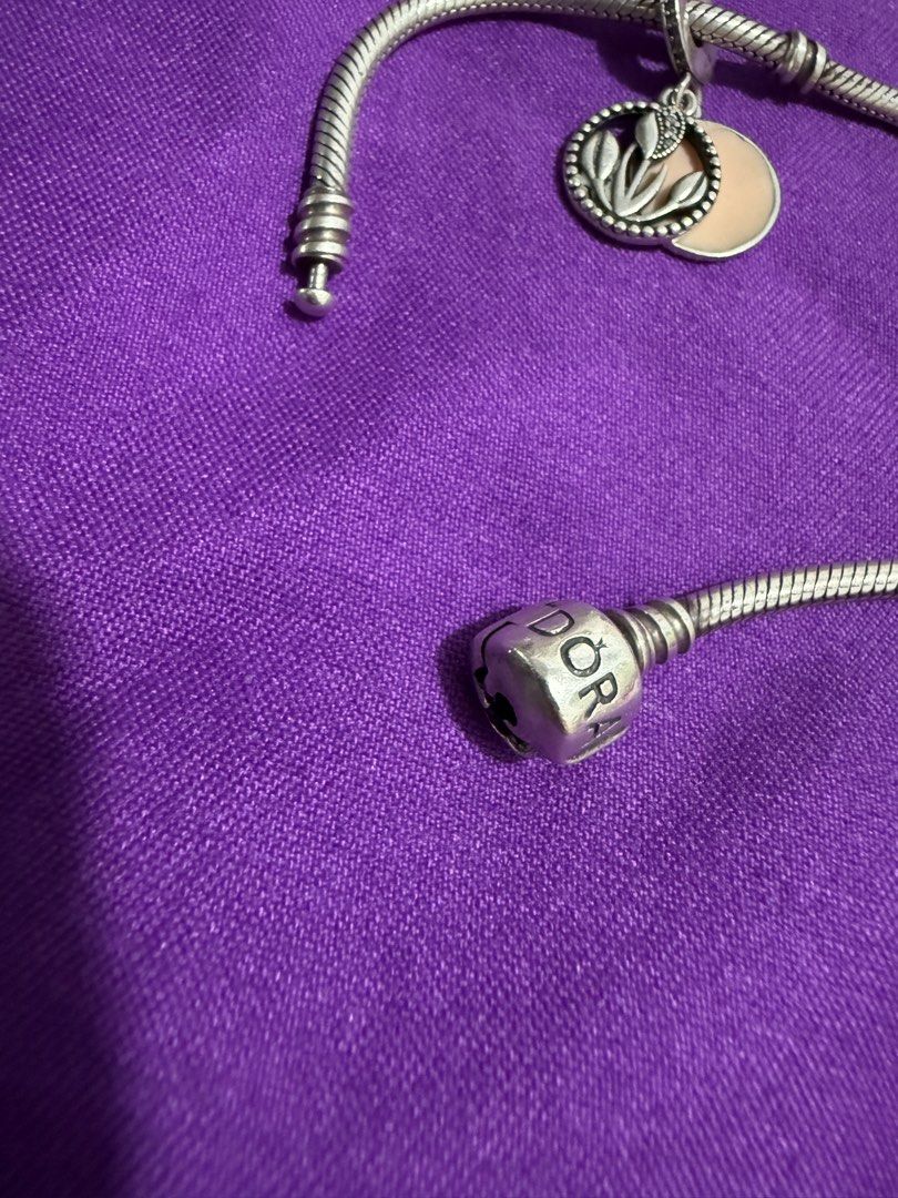 Pandora Sterling Silver Bracelet with Charms (Category: Bracelets) located in Manila. Submitted by lbiliran1346900 (Listing ID 1453486323, Image 3). Description: - Authentic Sterling Silver Pandora Bracelet - Classic Snake Chain Style - Pandora Logo Engraved on Clasp - Comes with 2 Charms: Floral with Pink Enamel & Plain Circle - Functional Clasp, Ready for New Charms.