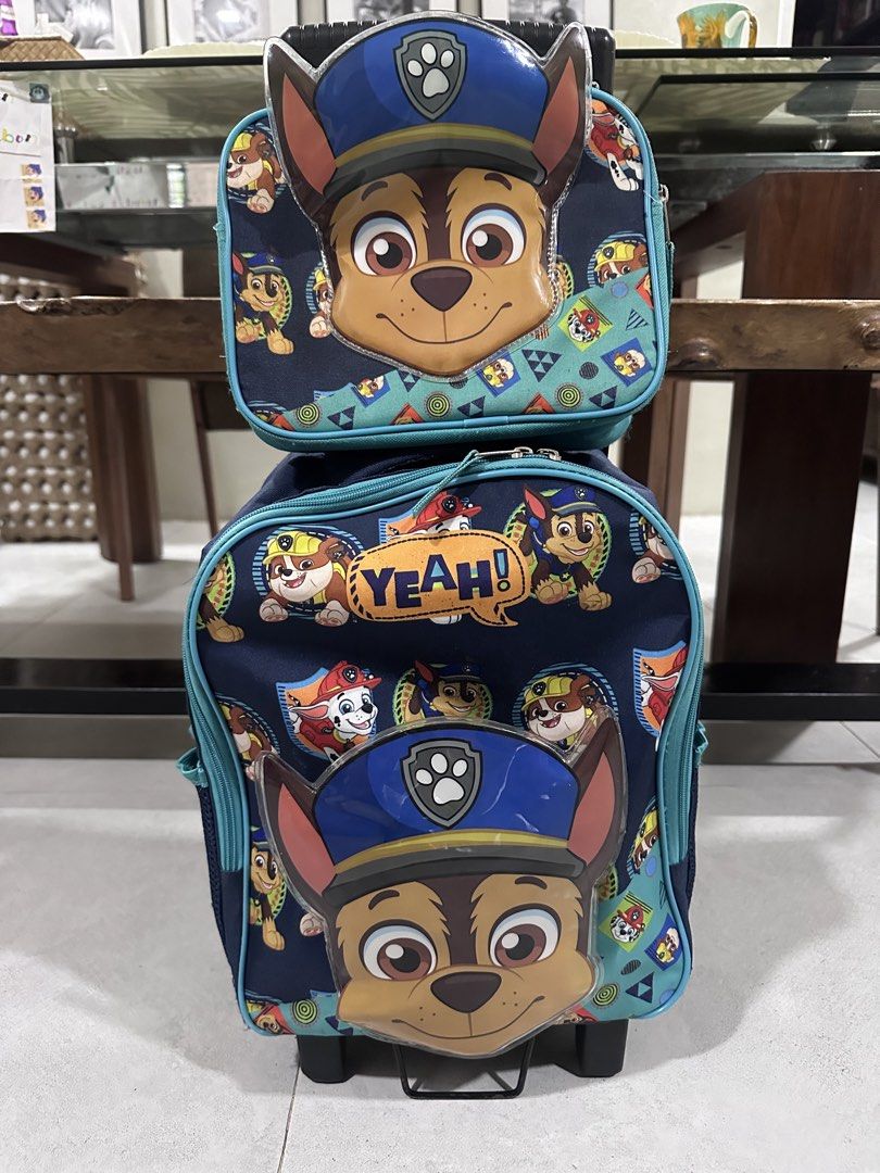 Paw Patrol Chase Rolling Backpack with Detachable Lunch Bag (Category: Babies & Kids Fashion) located in Makati City. Submitted by Pipie (Listing ID 1453433078, Image 2). Description: - Adorable Paw Patrol rolling backpack featuring Chase. - Comes with a matching, detachable lunch bag. - Equipped with wheels and a retractable handle for effortless transport. - Ideal for school, travel, or everyday adventures. - Decorated with multiple Paw Patrol 
